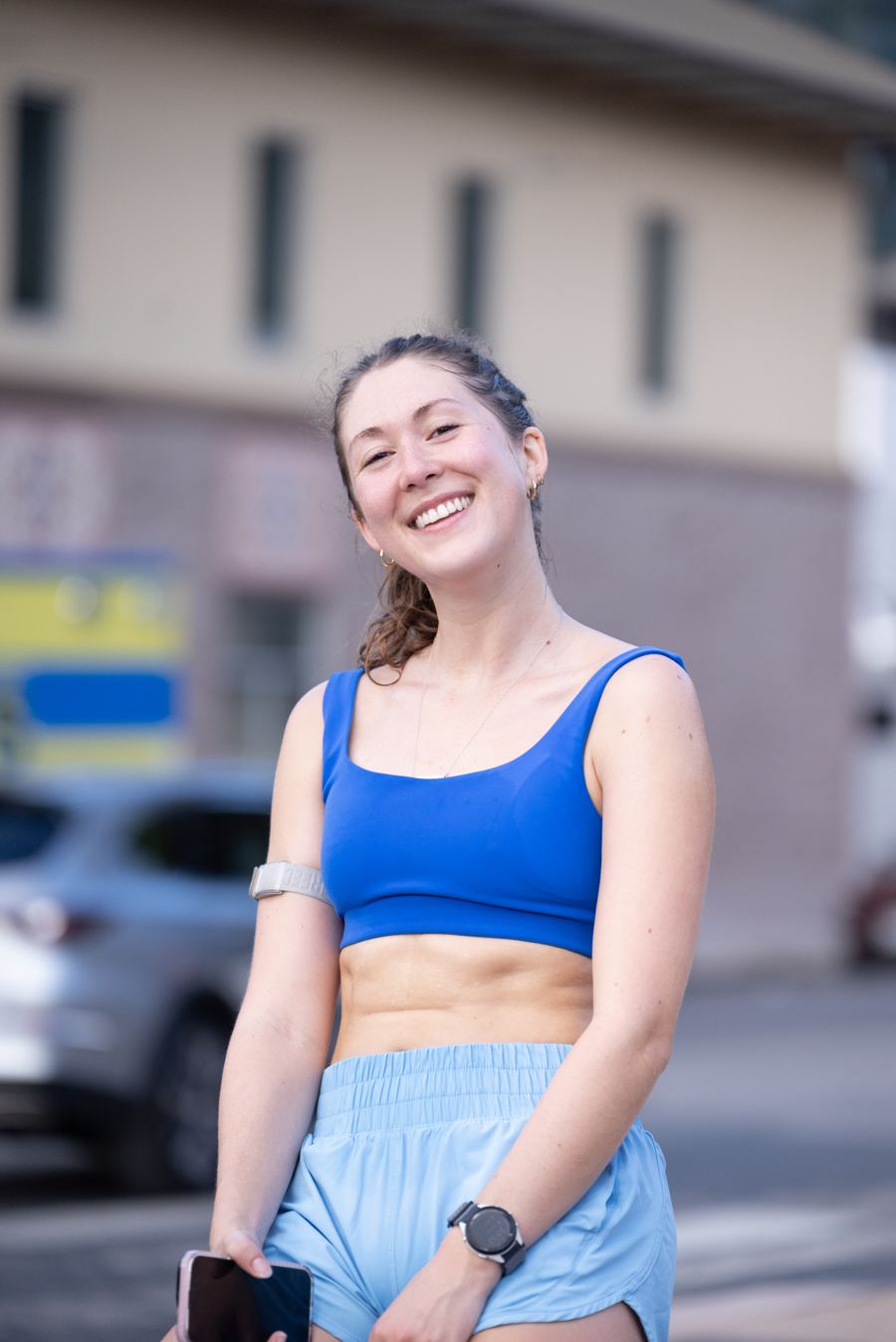 A smiling runner during a stop on the UT campus